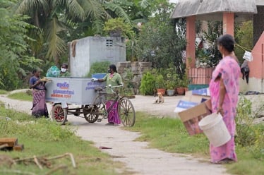 Mobile collection cart approaching a household